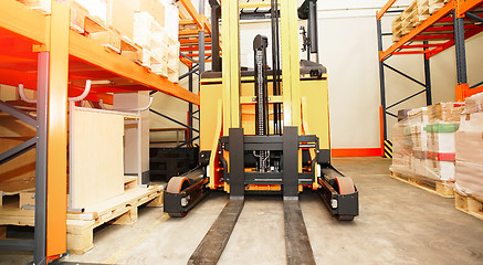 Image showing Forklift, shelves and racks with pallets in distribution warehou