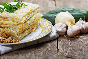 Image showing Stack of closed pizza and vegetables