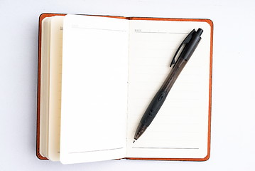 Image showing notepad with pen isolated