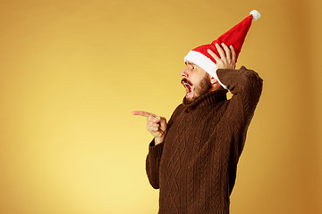 Image showing The serious christmas man wearing a santa hat