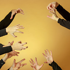 Image showing Many hands reaching out up in the air