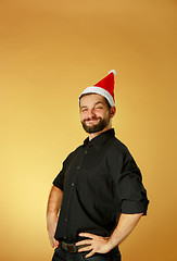 Image showing Smiling christmas man wearing a santa hat