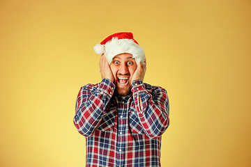 Image showing Smiling christmas man wearing a santa hat