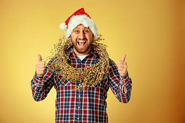 Image showing Smiling christmas man wearing a santa hat