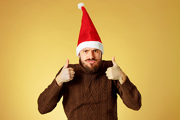 Image showing The serious christmas man wearing a santa hat