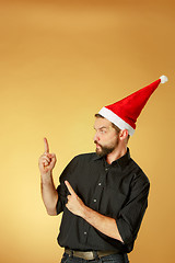 Image showing The serious christmas man wearing a santa hat