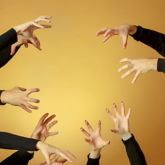 Image showing Many hands reaching out up in the air