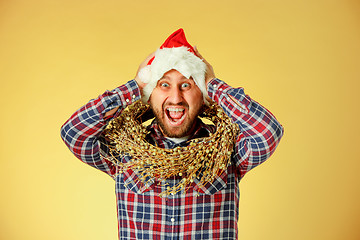 Image showing Smiling christmas man wearing a santa hat