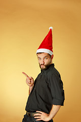 Image showing The serious christmas man wearing a santa hat