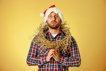 Image showing Smiling christmas man wearing a santa hat