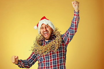 Image showing Smiling christmas man wearing a santa hat