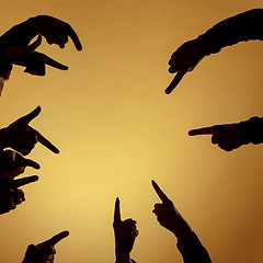 Image showing Many hands pointing ahead or out on orange background