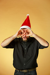 Image showing The Surprised christmas man wearing a santa hat