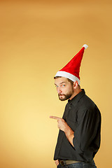 Image showing The serious christmas man wearing a santa hat