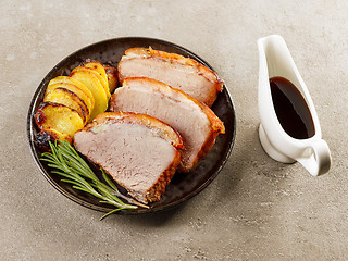 Image showing roasted pork slices and potatoes
