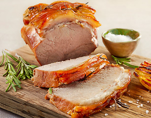 Image showing roasted pork on wooden cutting board