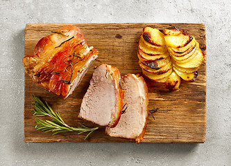 Image showing roasted pork on wooden cutting board