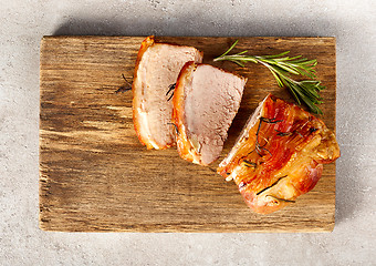 Image showing roasted pork on wooden cutting board