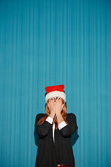 Image showing Surprised christmas girl wearing a santa hat