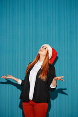 Image showing Surprised christmas girl wearing a santa hat