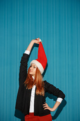 Image showing The christmas girl wearing a santa hat