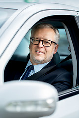 Image showing happy senior businessman driving car