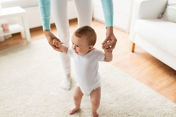 Image showing happy baby learning to walk with mother help