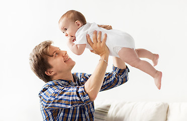Image showing happy young father playing with baby at home