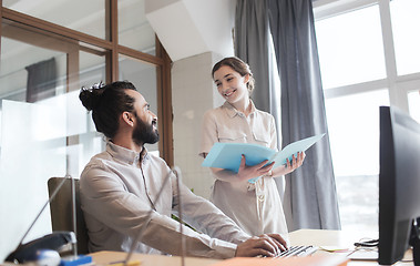 Image showing happy creative team with computer in office