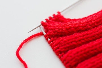 Image showing hand-knitted item with knitting needles