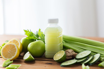 Image showing close up of bottle with green juice and vegetables