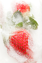 Image showing Strawberries partially frosen in ice