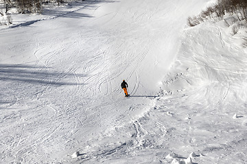 Image showing Skier on ski slope at sun winter day