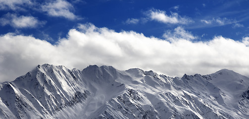 Image showing Panoramic view on snow winter mountains and sunlight cloud sky i