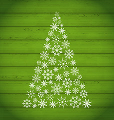 Image showing Christmas pine made of snowflakes on wooden background