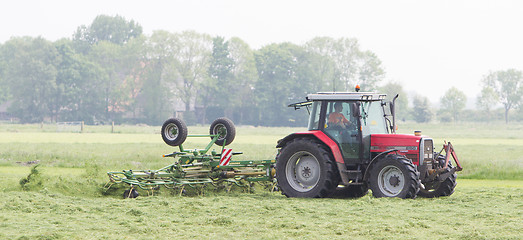 Image showing Leeuwarden, the Netherlands - May 26, 2016: Farmer uses tractor 