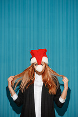 Image showing The christmas girl wearing a santa hat