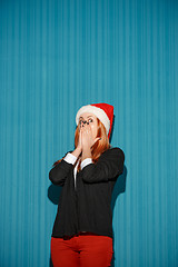 Image showing Surprised christmas girl wearing a santa hat