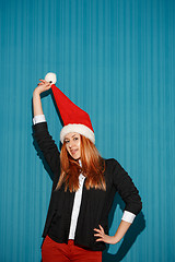 Image showing The christmas girl wearing a santa hat