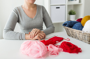 Image showing woman with knitting needles and yarn in basket