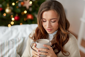 Image showing happy woman drinking cocoa at home for christmas