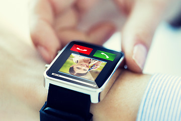 Image showing close up of hands with incoming call on smartwatch