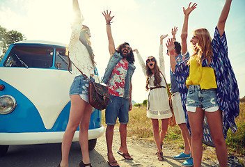 Image showing smiling hippie friends having fun over minivan car