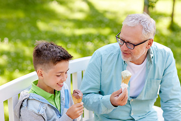 Image showing old man and boy eating ice cream at summer park