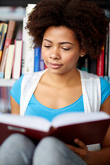 Image showing african student girl reading book at library