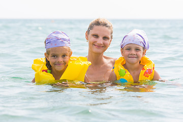 Image showing Mother and two daughters swimming in the sea