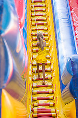 Image showing Girl with a rope climbs a high hill on the trampoline