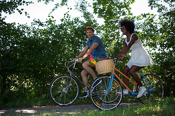 Image showing Young multiethnic couple having a bike ride in nature