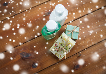 Image showing handmade soap bars and lotions on wood