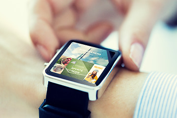 Image showing close up of hands with application on smartwatch